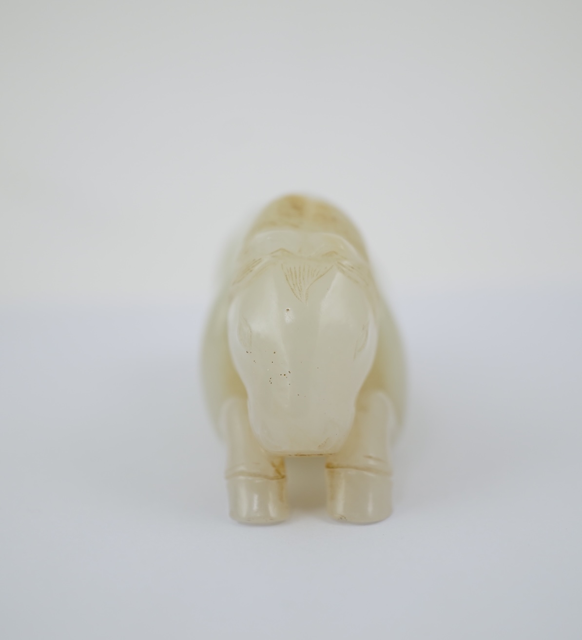 A Chinese white jade figure of a recumbent horse